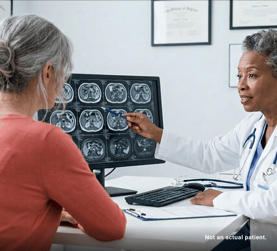 Specialist reviewing PET scan imaging with a patient with GEP-NETs.