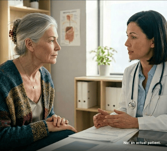 Healthcare provider discussing GEP-NET treatment options with patient during referral consultation.